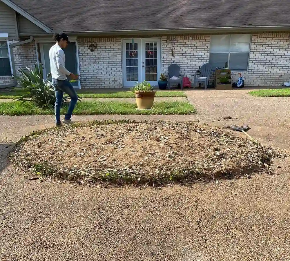 A man with a shovel stands in a Harlingen yard prepared for tree planting by Gold Tree Trimming LLC.